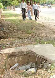 An uncovered manhole in front of the Sector 20 market. 