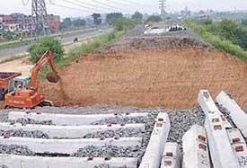 A JCB removes earth from a section of the Chandigarh -Ludhiana railway line near Jagatpura village.