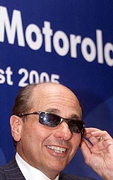 Chief Executive Officer of Motorola Inc Ed Zander wears a pair of sunglasses fixed with Bluetooth technology at a news conference in Bangalore