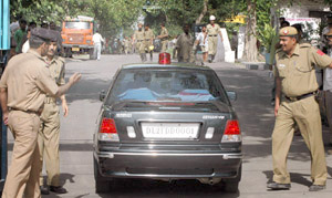 Security personnel outside the IP power plant where a chimney toppled, while Delhi Minister of Power Haroon Yusuf visits the site of the mishap in the Capital on Wednesday.