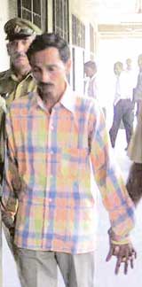 Parmod being taken away by the police after he was awarded the death sentence for murdering a child in Jagadhri on Wednesday.