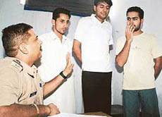 The three arrested accused (from left)  Ajaypal, Mandeep and Tanveer  with Model Town SHO Rajesh Sharma. 