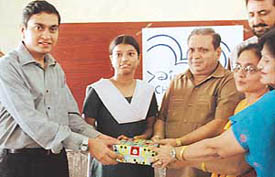 Sumit Shina of NM Jain Girls Senior Secondary School, Ludhiana, receives an award for winning Disney Channels Kim possible code tod from Mr K. Seshasaye, Head, Public Relations, Walt Disney, at a function held in the school on Wednesday. 
