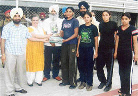 Girls receive trophy from Ms Amrit Kaur Gill, SDM, Ludhiana, at a prize distribution function of the Ludhiana District Inter-Block Rural Tournament held at Guru Nanak Stadium. Mr Gianinder Singh, DSO, and Mr J.P. Singh, Secretary, Zila Parishad, are also seen in the picture