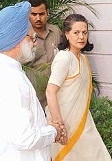 Congress President Sonia Gandhi and Prime Minister Manmohan Singh on the way to attend a CWC meeting at the formers residence in New Delhi on Friday.
