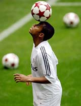 Robinho of Brazil, Real Madrids new soccer player, balances a ball during a presentation ceremony at Santiago Bernabeu stadium in Madrid on Friday