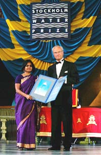 Swedish King Carl XVI Gustaf poses with Sunita Narain and the Stockholm Water Prize diploma awarded to Narain at the Concert Hall in Stockholm on Thursday.