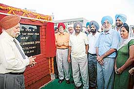Former hockey Olympians lay the foundation stone for a six-a-side polygrass turf at Shivalik Public School, Phase VI, Mohali, on Sunday. The school Principal, Mr D.S. Bedi, is on the left. 