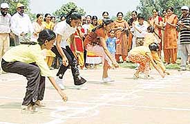 Children take part in a potato race during the sports meet organised by the Sree Ayyappa Seva Samiti at Mohali on Sunday. 