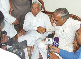 Mr Bhajan Lal, President, Haryana Congress, and Chief Minister Bhupinder Singh Hooda at a joint press conference held at the party headquarters in Chandigarh on Sunday.