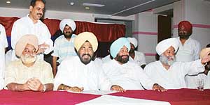 PCC president Shamsher Singh Dullo flanked by Tej Parkash, on his right, and Mr Nahar Singh Gill addresses a press conference in Ludhiana on Sunday. 