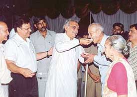 Mr Bhupinder Singh Hooda, Chief Minister of Haryana, offers sweets to Dr Sansar Chandra on his 89th birthday at his residence in Chandigarh