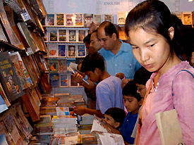 Visitors at a stall at Delhi Book Fair, currently on at Pragati Maidan in the Capital
