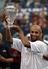 James Blake holds the trophy after defeating Feliciano Lopez in the final of the Pilot Pen Tennis Tournament in New Haven on Sunday