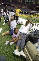 New Oleans residents sit in the Superdome which is being used as an emergency shelter before the arrival of Hurricane Katrina