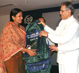 Delhi Lt. Governor B. L. Joshi handing over a rucksack kit to a pilgrim during the send-off ceremony of the 16th batch of pilgrims leaving for Mansarover Yatra 2005 at Raj Niwas in the Capital on Tuesday. 