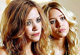 Mary-Kate Olsen and her twin sister, Ashley, listen to a reporters question during an interview in Toronto on Tuesday