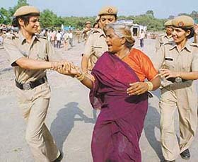 A protester being taken away by the Haryana policewomen during a demolition drive by HUDA at Sector 21, Panchkula