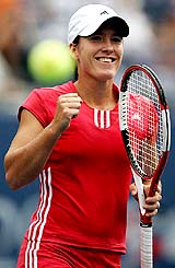 Justine Henin-Hardenne of Belgium exults after defeating Zuzana Ondraskova of the Czech Republic 