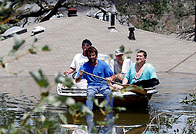 Residents search for survivors by boat in the neighbourhood surrounding Lake Pontchartrain  one day after Hurricane Katrina struck in New Orleans, Louisiana