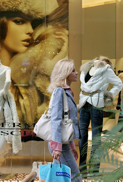 A woman walks past a fashion boutique in Petrovka Passage, one of Moscows most expensive shopping centres, on Thursday. The Russian capital has become one of the top shopping destinations for label lovers, with exclusive boutiques dotting malls that ooze glamour and wealth.