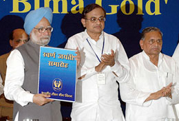Prime Minister Manmohan Singh is accompanied by Finance Minister P. Chidambaram and Uttar Pradesh Chief Minister Mulayam Singh Yadav during the golden jubilee celebrations of the Life Insurance Corporation of India