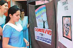 Students of Dev Samaj College of Education, Sector 36, Chandigarh, take a look at the poster exhibition on eye donation put up by students on Thursday.
