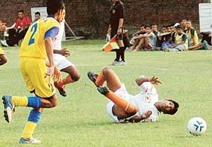 Rinku (on ground) of the Chandigarh Football Academy loses control during a match against the Goa Football Association at the Chandigarh Junior Challenge Football Cup (u-17) in Sector 42, Chandigarh, on Thursday.