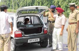 Security officers check a car of SOPU activists on the PU campus in Chandigarh on Thursday.