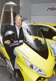 Motoatsu Shiraishi, Senior Managing Director of Honda Motors and President of Honda R&D, rides the companys ASV-3 (3rd-generation Advanced Safety Vehicles) motor cycle at Tokyo on Friday. Honda unveiled the ASV-3 vehicles, a motor cycle and a car, equipped to exchange positional information with other vehicles using inter-vehicle communication technology. 