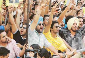 Supporters of SOPU cheer their leaders during the Open House debate at the Students Centre in Panjab University, Chandigarh, on Friday.
