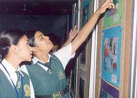 Children of Satluj Public School admire paintings on the theme of road safety made by schoolchildren of South Asian countries.
