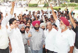 Dealers of second-hand cars stage a protest in Ludhiana on Friday