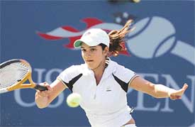 Sania Mirza plays a return shot to Marion Bartoli of France during their third-round match at the US Open in New York on Friday
