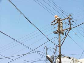 PSEB linemen replace wires in Kundanpuri in the Civil Lines area on Saturday