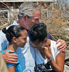 President George Bush comforts Kim Bassier and Bronwynne Bassier while touring in Biloxi, Missisippi