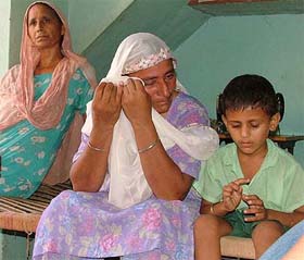 Ms Balwinder Kaur, Hardeep Singhs mother, wipes tears while she recalls events at Seelon Kalan village