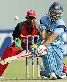 Indian batsman Yuvraj Singh sweeps a delivery as Zimbabwe wicketkeeper Tatenda Taibu looks on during a tri-series match at the Harare Sports Club