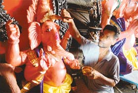 An artist from West Bengal gives final touches to a Ganesha idol at the Kalibari temple, 3BRD, Chandigarh