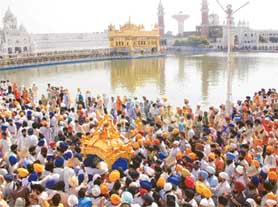 The colourful Nagar Kirtan moving towards the Golden Temple.