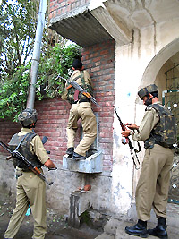 Securitymen comb the area around Neelam Cinema in Srinagar on Wednesday after militants tried to storm the Civil Secretariat
