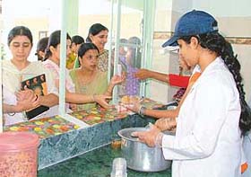 Students serve healthy snacks at the “students canteen” on the concluding day of the Nutrition Week at the Ramgarhia College for Women in Ludhiana