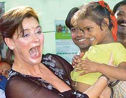 British Premier Tony Blairs wife Cherie with a child during her interaction with the street children, sheltered by the Salam Balak Trust, in New Delhi on Wednesday.