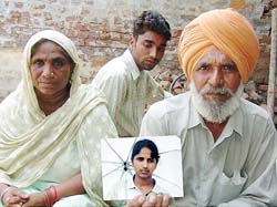 Parents show a photo of Virpal who has been held hostage in Singapore.