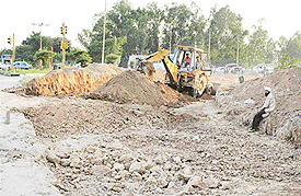 Work in progress for laying of 6-lane road between the railway light point and IT park in Kishangarh.