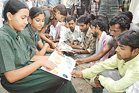 Students of Jeevan Mukt Nishulakh Vidyalaya, Sector 9, Panchkula, educate labourers to mark International Literacy Day at Labour Chowk in Sector 16, Panchkula, on Thursday.