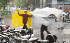 People try to take shelter with anything they can lay their hands on as heavy rain lashed the city in the afternoon on Thursday.