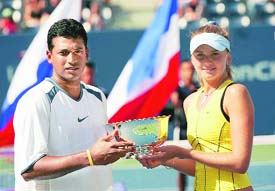 Indias Mahesh Bhupathi and Daniela Hantuchova of Slovakia hold the winners trophy after defeating Katarina Srebotnik of Slovenia and Nenad Zimonjic of Serbia & Montenegro in the mixed doubles final at the US Open in New York on Thursday. 