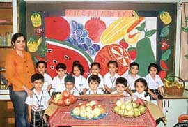 Students of Small Wonders School, Phase VII, Mohali, prepare fruit chat during the health awareness week.