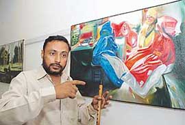 Artist J.S. Goga with his paintings on display at Gallery Jodh in Sector 11, Chandigarh, on Friday. 